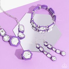 A vivid, faceted, white gem is pressed into the center of a hexagonal purple rubber-like frame, creating a powerful pop of color atop the finger. Features a stretchy band for a flexible fit.

 Sold as one individual ring.

Get The Complete Look!
Bracelet: "Transforming Taste - Purple" (Sold Separately)
Earring: "Developing Dignity - Purple" (Sold Separately) Gray Earrings, Purple Rings, Brown Bracelet, Purple Bracelet, Brown Necklace, Orange Earrings, Red Necklace, Purple Earrings, Red Bracelets