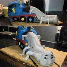 the cake is shaped to look like a train and has an alligator on it's side