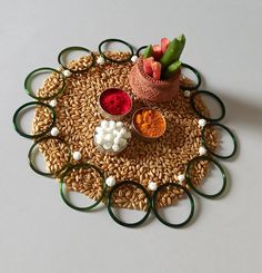 an arrangement of food is arranged on a round table mat with green rings around it