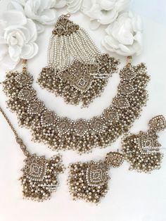 Elegant Pakistani bridal set with Jhoomer/antique gold base white stones/dual tone/Pakistani Jewelry/ Indian and Pakistani wedding jewelry/ Bollywood jewelry/ kundan and Polki jewelry This elegant necklace set comes with Earrings, tikka and Jhoomer/Passa. All items are shipped from Brampton, Ontario, Canada. If you need your item by a certain day, please reach out to us for express delivery option before placing the order so that we can update the shipping for you. Standard shipping/delivery timeline Below are the delivery timeline estimates. We dispatch all orders by the next business day. ---> USA delivery timeline * 3-6 business days to major urban centers in USA. It may take 1-2 days extra to remote locations ---> Canada delivery timeline  * 2-3 business days - GTA  & Montreal  * 2-4 Pakistani Wedding Jewelry, Pakistani Necklace, Tikka Jewelry, Brampton Ontario, Jewelry Kundan, White Stones, Bollywood Jewelry, Polki Jewellery, Pakistani Jewelry