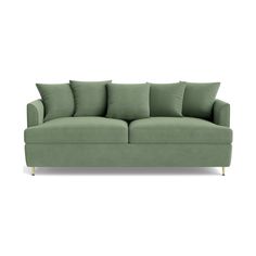 a green couch with pillows on it