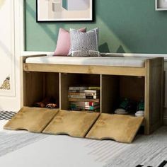 a wooden bench sitting in front of a wall filled with pictures and books on it