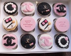 a box filled with lots of cupcakes decorated like chanel and chanel logo