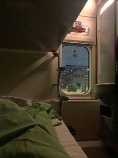 there is a window in the side of a train car that looks out onto a city