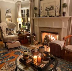 a living room filled with furniture and a fire place in the middle of the room