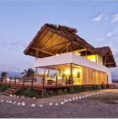 a house with a thatched roof on the beach