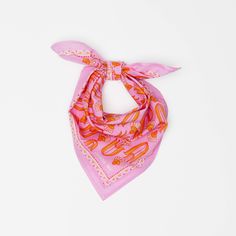 a pink bandana with an orange and white design on the front, sitting against a white background