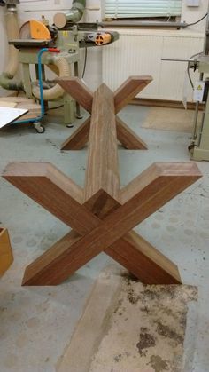 a wooden sculpture sitting on top of a table in a room filled with woodworking tools