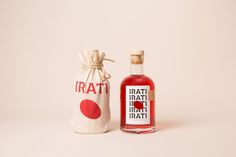 a bottle of red liquid next to a bag with the word irati on it