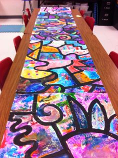 the long table is covered with colorful paper