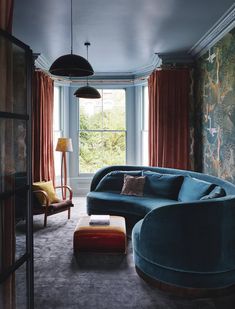 a living room filled with furniture next to a window