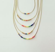 "Rainbow necklace beaded, Gay Pride necklace, Equality flag. This listing for one necklace. All version are available in gold tone or silver tone. DETAILS - Japanese color glass seed beads - Dainty but strong chain - Necklace Version (Rainbow). Available 7 versions with gold tone chain&spacers and 7 with silver tone chain&spacers. You can also create your own version :) - Necklace Length. Choose in the drop down menu (1 inch = 2.5 cm) - Two stoppers preventing glass beads from sliding on Pride Necklace, Flag Pride, Japanese Colors, Lgbt Flag, Celestial Necklace, Rainbow Jewelry, Rainbow Necklace, Wedding Jewellery Necklace, Pride Flag