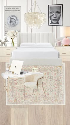 a white bed sitting next to a table with a laptop on top of it in front of a chandelier