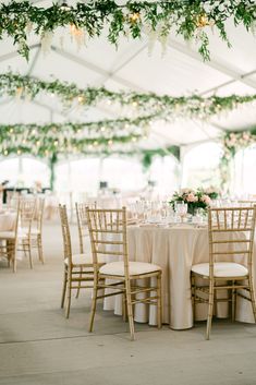 A hanging greenery installation transforms the Wedding Tent at Bella Terra Vineyard in Niagara-on-the-Lake Wedding Tent Garland, Wedding Ceiling Decorations Greenery, Indoor Wedding Reception Decorations Hanging Lights, Simple Wedding Ceiling Decorations, Tent Wedding Greenery, Wedding Reception Flowers Hanging, Hanging Wedding Florals, Greenery On Ceiling, Wedding Tent Greenery