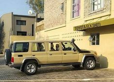 an suv is parked in front of a building