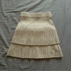 Short Knitted Skirt In A Cream Color Way, New Chic Knit Mini Skirt For Spring, Knit Mini Skirt For Spring, Spring Ribbed Beige Skirt, Casual Beige Ribbed Skirt, Spring Knit Mini Skirt, Cream Mini Skirt With Lined Detail, Blue Tennis Skirt, Light Brown Boots, Envelope Skirt