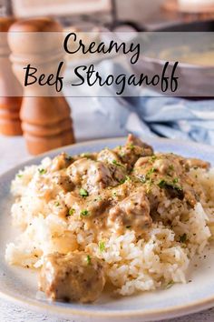 creamy beef stroganoff served over rice on a plate