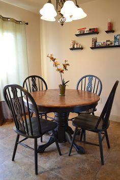 a dining room table with four chairs around it