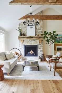 a living room filled with furniture and a fire place in the middle of a room