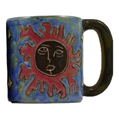 a ceramic mug with a face on it's side and the words sun above it