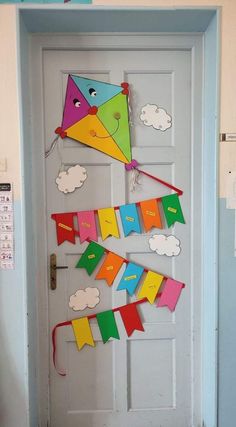 a door decorated with colorful kites and clouds