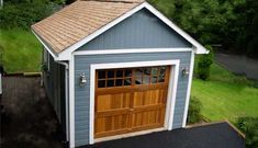 an overhead view of a garage with two doors on the side and one door open