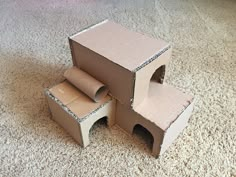 two cardboard boxes sitting on the floor next to each other with one open and another closed