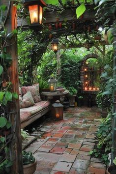 an outdoor seating area is surrounded by greenery and lit up with lanterns in the distance