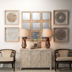 a living room filled with furniture and pictures hanging on the wall above it's sideboard