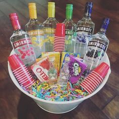 a white bowl filled with lots of different types of liquors and confetti