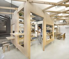 a person standing in a room with wooden shelves