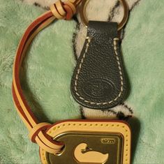 This Listing Is A Gorgeous Dooney Grey Keyring And A Leather & Gold Hangtag Charm Bag Jewerly. Great Set If You Need A Tag Replacement For Any Of Your Dooney Bags And A Chance To Get A Dooney Keyring,Too. See Pics For Details. Keychain Leather, Dooney & Bourke Bag, Dooney Bourke Handbags, Patent Leather Handbags, Drawstring Bucket Bag, Brown Shoulder Bag, Dooney & Bourke Bags, Leather Wristlet, Leather Keychain