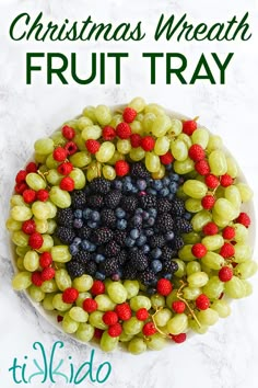 christmas wreath fruit tray with raspberries, grapes and blackberries in the center