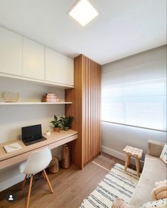 a room with a desk, chair and laptop on it