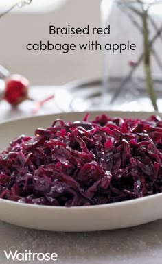 a white bowl filled with red cabbage on top of a table