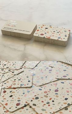 several different types of business cards sitting on top of each other, one is white and the other has multicolored dots