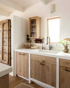 a kitchen with wooden cabinets and white counter tops