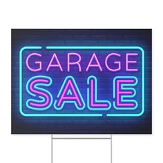 a garage sale sign with neon lights on it