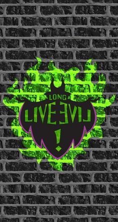 a brick wall with the words long live evil painted on it in green and purple