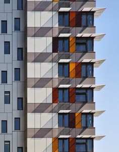 a tall building with many windows and balconies