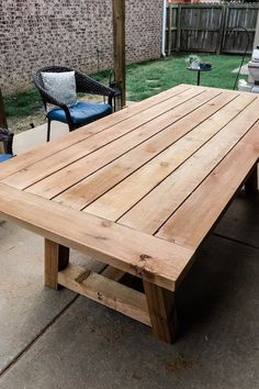 a wooden table sitting on top of a patio