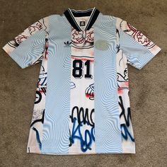 Brand New Never Worn - Adidas Jersey Originally Bought From Pharmacy In Perfect Condition! Casual Blue Graffiti Print Top, Casual Blue Tops With Graffiti Print, Casual Blue Top With Graffiti Print, Blue Graffiti Print Tops For Streetwear, White Fitted Tops With Graffiti Print, White Urban Tops With All Over Print, Urban White Tops With All Over Print, Adidas Jersey, Adidas Skateboarding