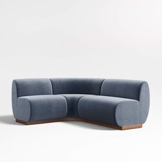 a blue couch sitting on top of a white floor