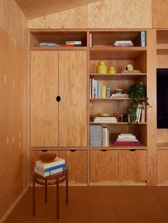 an entertainment center with wooden shelves and bookshelves