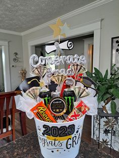 a bucket filled with lots of candy and confetti on top of a table