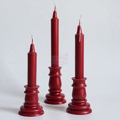 three red candles sitting next to each other