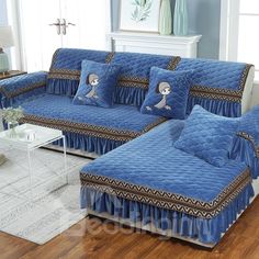 a blue couch with pillows on it in a living room