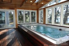 an indoor jacuzzi is shown in the middle of a wood floored room