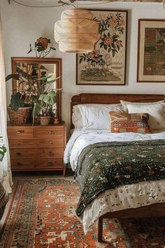 a bed room with a neatly made bed and lots of pictures on the wall above it