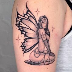 a woman with a butterfly tattoo on her arm